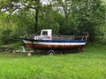 Old boat sits on a trailer in a remote forest area, its mooring untethered Royalty Free Stock Photo