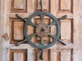 Old boat steering wheel on wooden door Royalty Free Stock Photo