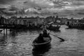 A old boatman and passenger on the river under cloudy sky Royalty Free Stock Photo