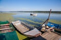 Old boats anchord on a ruined pontoon on the Danube river in Serbia, during a sunny afternoon.