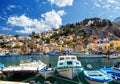 Old boats docked in the gulf of Symi island in Greece