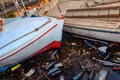 Old boats moored in dirty harbour. Pollution of river, sea, ocean water with waste, plastics garbage. Royalty Free Stock Photo