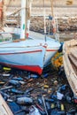 Old boats moored in dirty harbour. Pollution of river, sea, ocean water with waste, plastics garbage Royalty Free Stock Photo