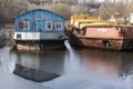 Old boatstation with blue houseboat