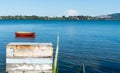 Old boatwood box on edge of blue harbour Royalty Free Stock Photo