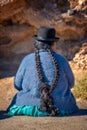 Old bolivian woman in traditional outfit with a hat and long braids Royalty Free Stock Photo