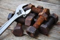 Old bolts with adjustable wrench tools on wooden background