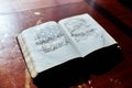 Old book with ancient text on a wooden table