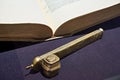 Old book and bronze divit for pen Royalty Free Stock Photo