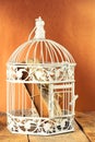 Old book in closed decorative cage, on wooden table. Royalty Free Stock Photo