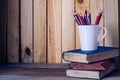 Old book and color pencil on a wooden floor - tone vintage. Royalty Free Stock Photo