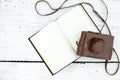 Old book and feather pen on vintage white wooden table Royalty Free Stock Photo