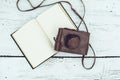 Old book and feather pen on vintage white wooden table Royalty Free Stock Photo