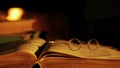 Old book and glasses in front of the fireplace.