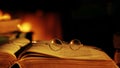 Old book and glasses in front of the fireplace.