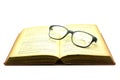 Old book and glasses isolated on white Royalty Free Stock Photo