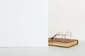 An old book and glasses on the table, on a white background, the concept of reading and learning. Copy space Royalty Free Stock Photo
