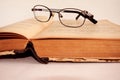 Old book and glasses on white background Royalty Free Stock Photo