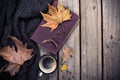 Old book, knitted sweater with autumn leaves and coffee mug Royalty Free Stock Photo