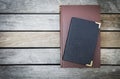 Old book with leather cover on vintage wooden floor background Royalty Free Stock Photo