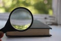 Old book and magnifying glass. Search information, SEO, education and knowledge concept Royalty Free Stock Photo