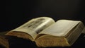 Old book pages detail. Stock footage. Open old book lying on the table with pages turning by wind. Royalty Free Stock Photo