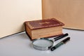 Old book,pen and magnifie Royalty Free Stock Photo