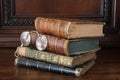 Old books piled on an antique wooden furniture Royalty Free Stock Photo