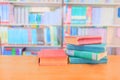 Old book red - green. heap are interior library school on wooden table and blurry bookshelves background. Royalty Free Stock Photo