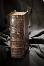 Old book spine. Ancient museum book with worn out hard cover. Ra