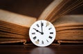 Old book and vintage clock, story time, storytelling background Royalty Free Stock Photo