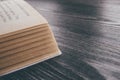 Old book wooden library desk, retro toned image, selective focus Royalty Free Stock Photo