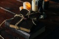 Old book on a wooden table by candlelight Royalty Free Stock Photo