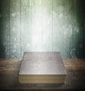 Old book on wooden table with green wood wall background Royalty Free Stock Photo