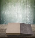 Old book on wooden table with green wood wall background Royalty Free Stock Photo