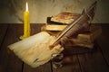 Old books, candle and feather with inks Royalty Free Stock Photo