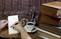 Old books coffee cup, compass and pencil on a wooden. Royalty Free Stock Photo