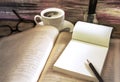 Old books with coffee cup, glasses and pencil on a wooden table Royalty Free Stock Photo