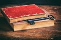 Old books and a key on a wooden desk Royalty Free Stock Photo