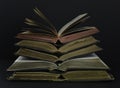 Old books with leather covers and red and gold yellow pages. Placed in pile on a dark background Royalty Free Stock Photo