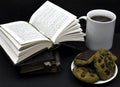 Old books with leather covers about to read. A cup of coffee or tea and vegan cookies ready to drink