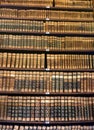 Old books at a library bookshelf Royalty Free Stock Photo