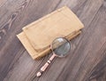 Old books and magnifying glass on the desk Royalty Free Stock Photo