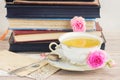 Old books and mail with cup of tea Royalty Free Stock Photo