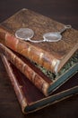 Old books piled on an antique wooden table Royalty Free Stock Photo