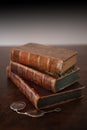 Old books piled on a antique wooden table Royalty Free Stock Photo