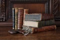 Old books piled on an antique wooden furniture Royalty Free Stock Photo