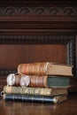 Old books piled on an antique wooden furniture