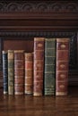 Old books piled on an antique wooden furniture Royalty Free Stock Photo