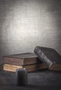 Old books for prayer with a magnifier and a black candle. Royalty Free Stock Photo